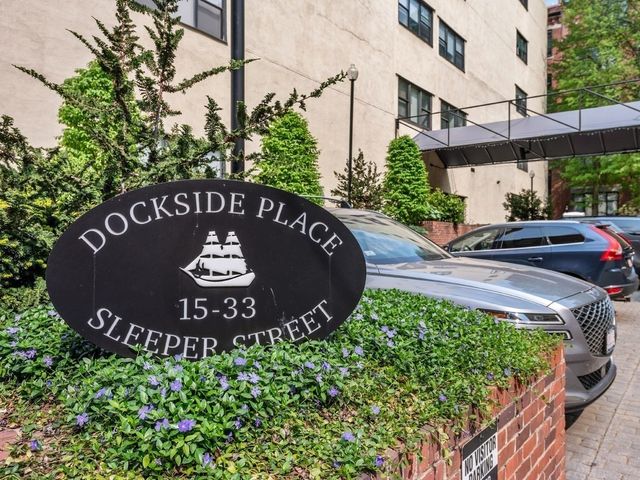 a view of a house with a small yard and wooden fence