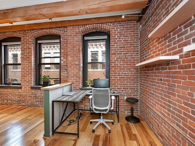 a view of a patio with table and chairs and wooden floor