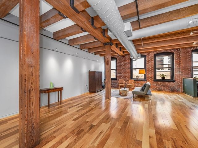 a view of a patio with dining table and chairs with wooden floor