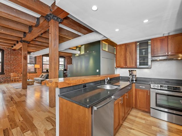 a kitchen that has a sink and a stove in it