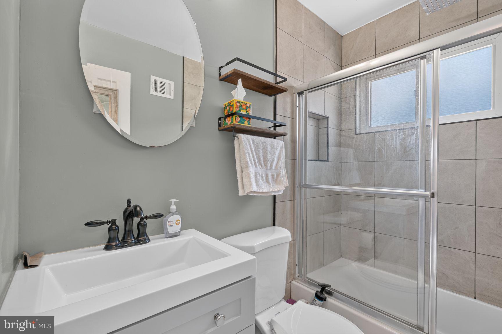 2437 Iverson Street Temple Hills, MD 20748 - Photo 11 of 15 a bathroom with a sink a toilet and shower