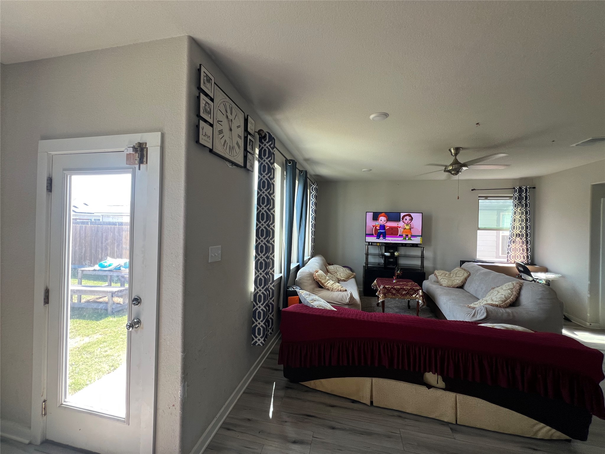 172 Coppers Way Elgin, TX 78621 - Photo 6 of 27 An open living space features durable wood patterned flooring and a glass exterior entry door.
