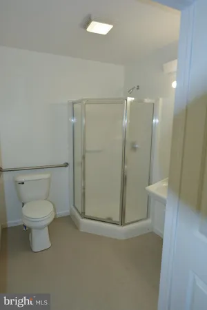 a bathroom with a toilet and a shower