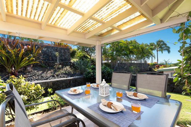 a outdoor dining room with furniture and a potted plant