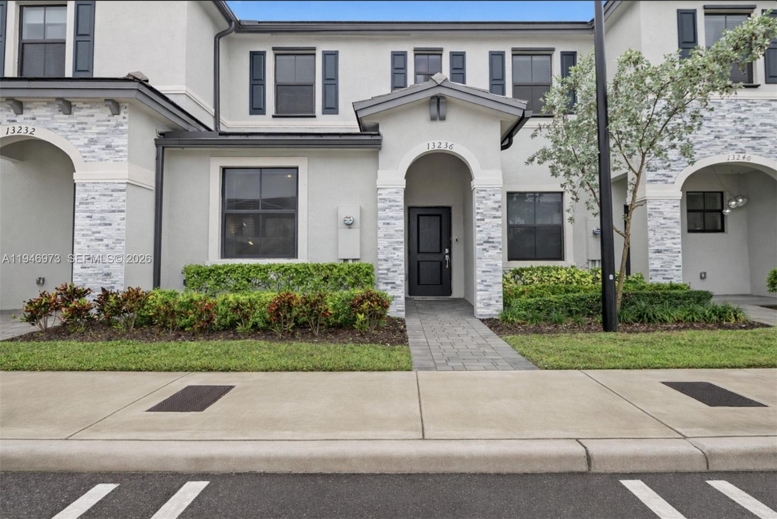 a front view of a house with garden