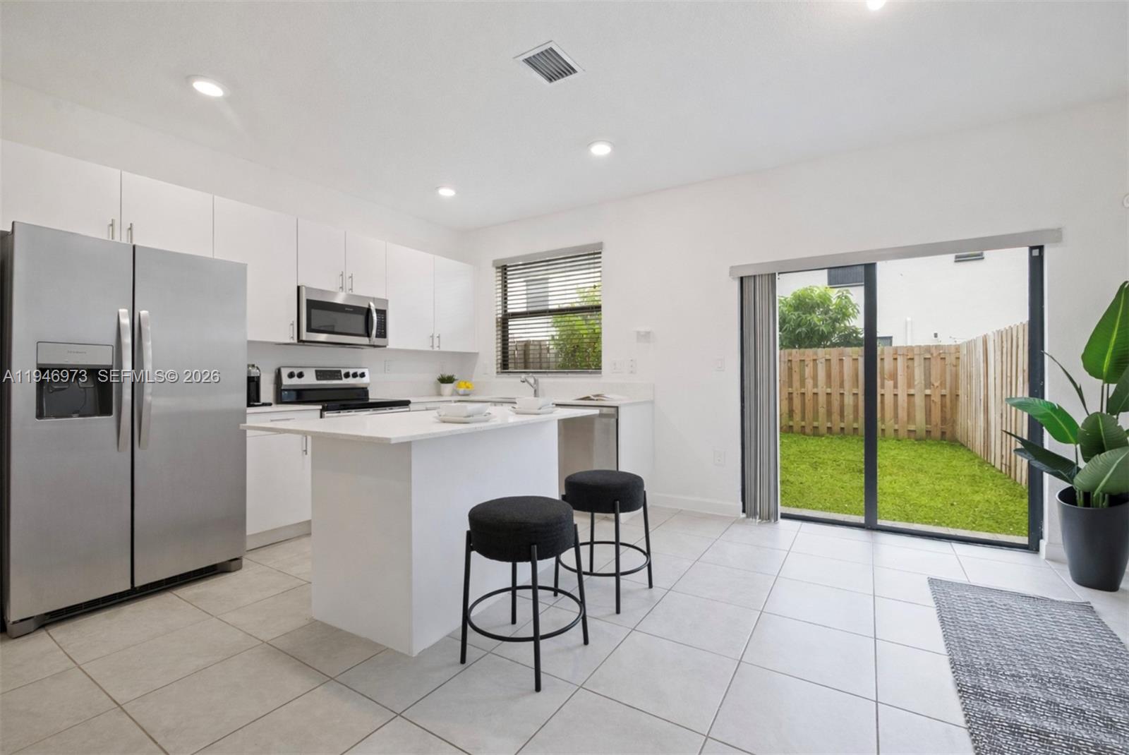 13236 Southwest 286th Street Homestead, FL 33033 - Photo 6 of 23 a kitchen with granite countertop a refrigerator and a sink