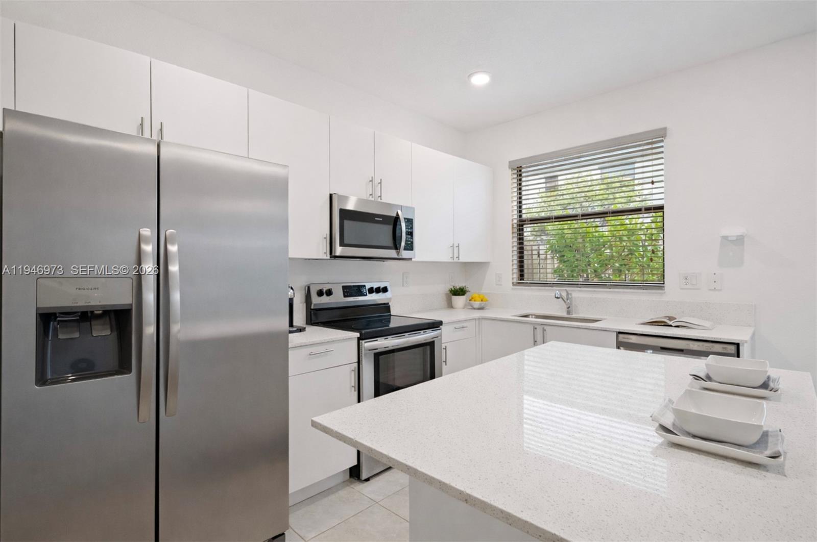 13236 Southwest 286th Street Homestead, FL 33033 - Photo 7 of 23 a kitchen with a refrigerator stove and sink