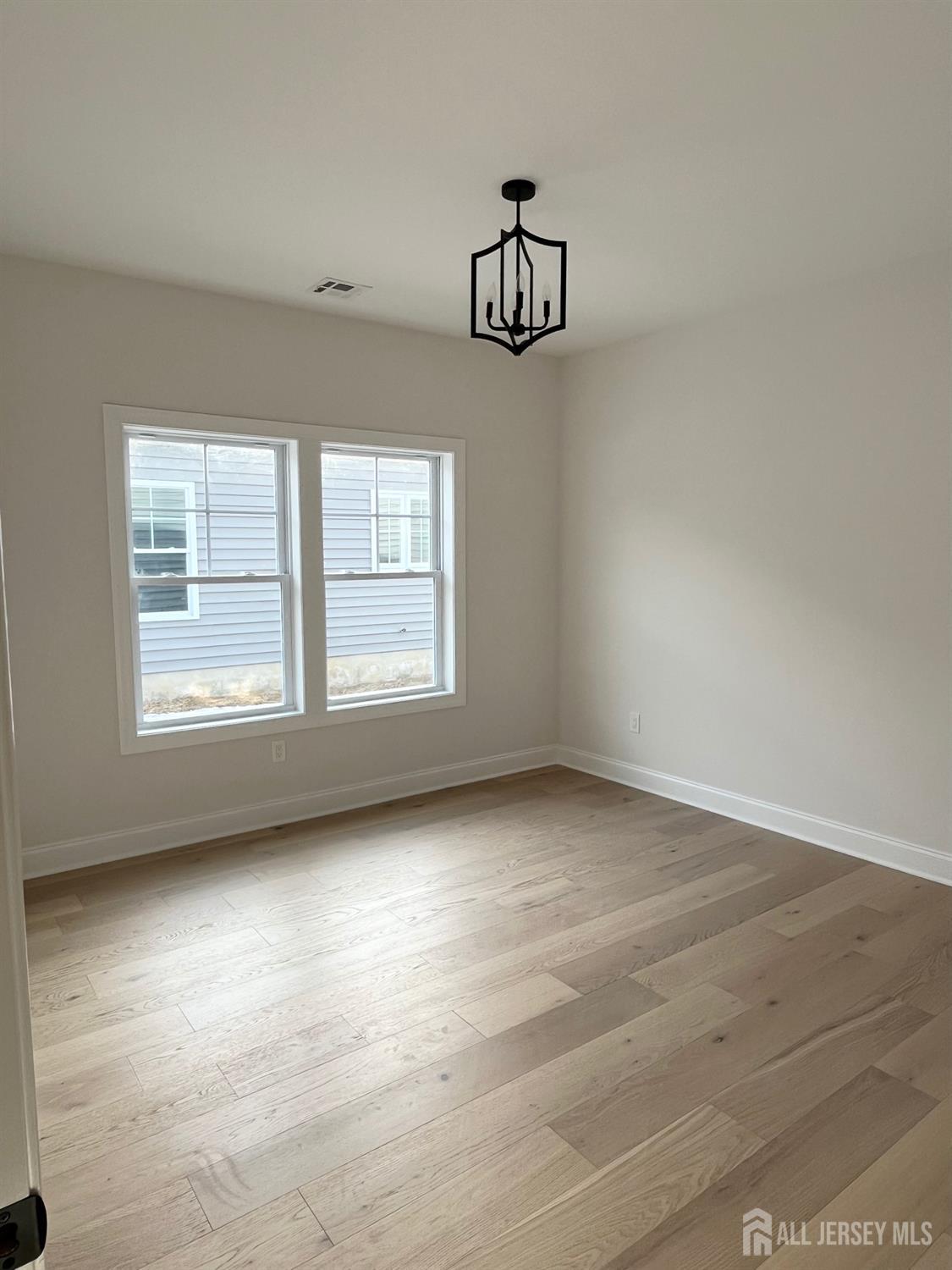 10 Johnson Avenue Matawan, NJ 07747 - Photo 12 of 26 an empty room with windows and cabinet
