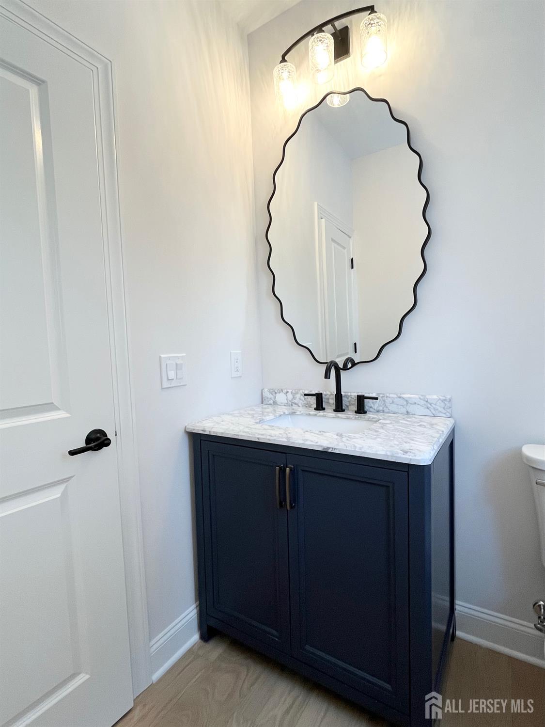 10 Johnson Avenue Matawan, NJ 07747 - Photo 16 of 26 a bathroom with a sink and mirror