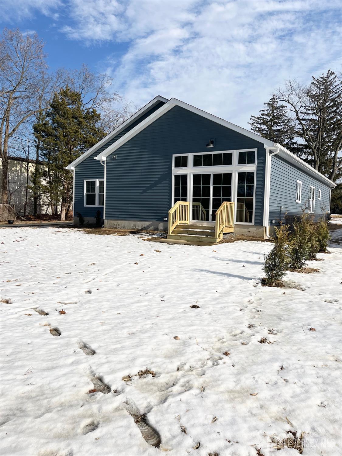 10 Johnson Avenue Matawan, NJ 07747 - Photo 24 of 26 a front view of a house with a yard covered in snow