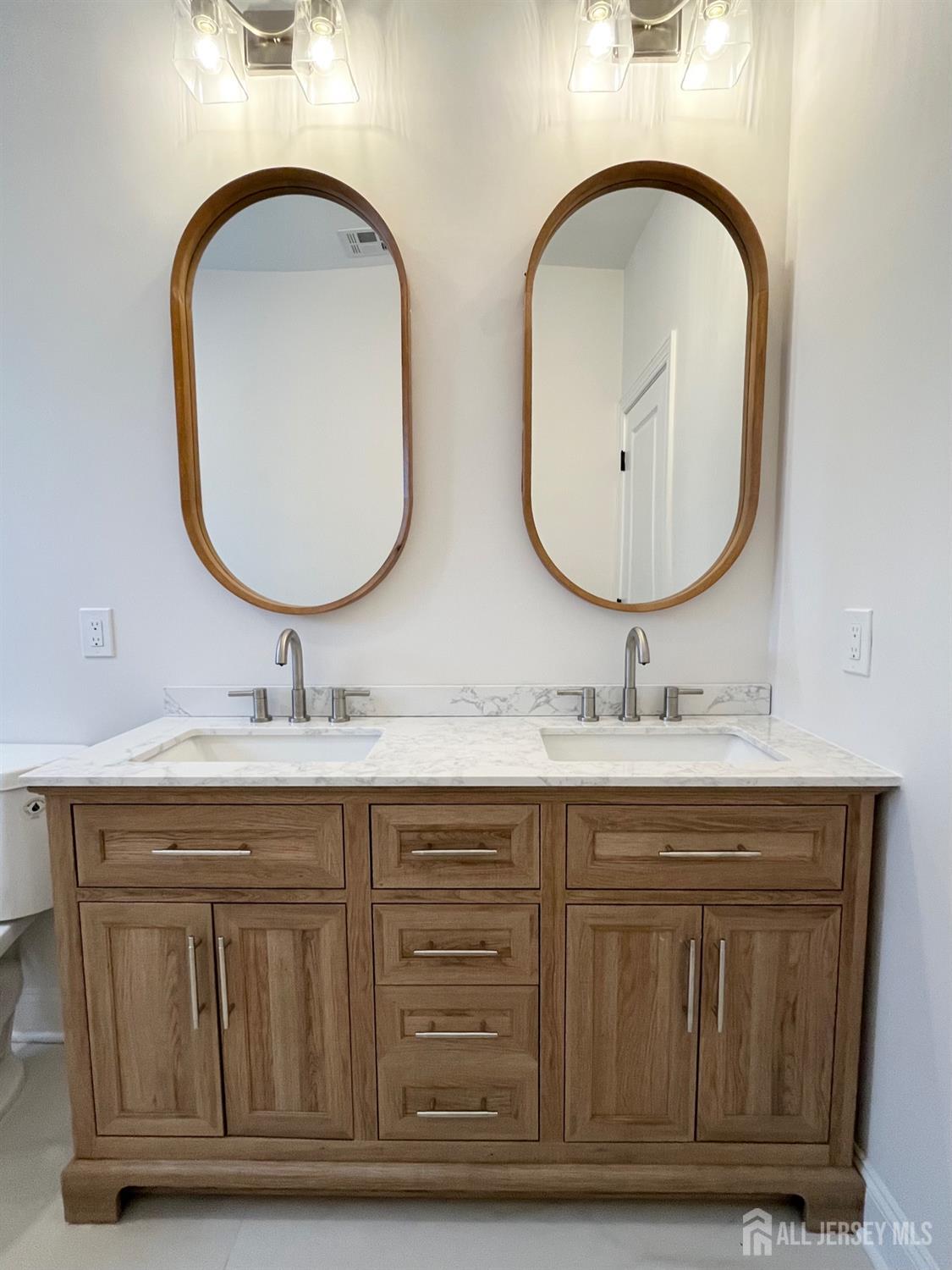10 Johnson Avenue Matawan, NJ 07747 - Photo 10 of 26 a bathroom with a granite countertop double vanity sink and a mirror
