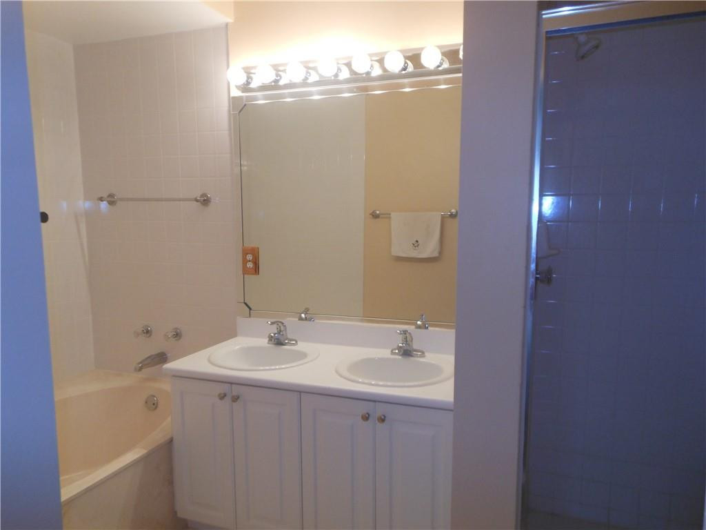 599 Racquet Club Road, Unit 65 Weston, FL 33326 - Photo 13 of 18 a bathroom with a sink and mirror