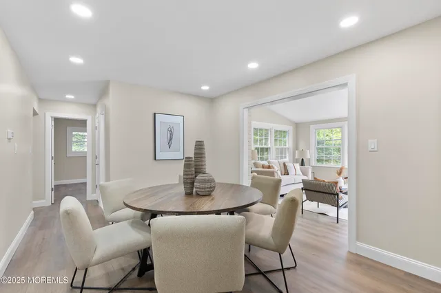 a dining room with furniture and wooden floor