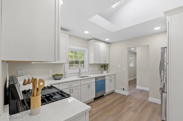 a kitchen with a sink a stove and refrigerator