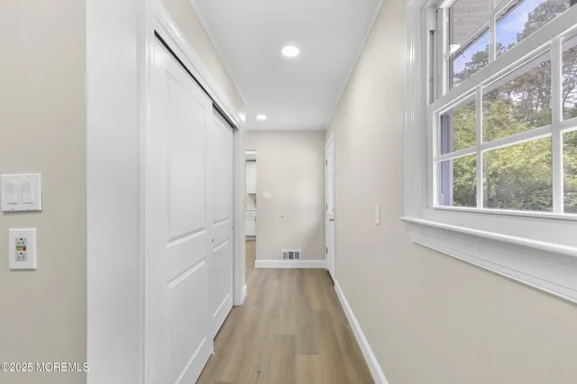 a view of a hallway with a large window