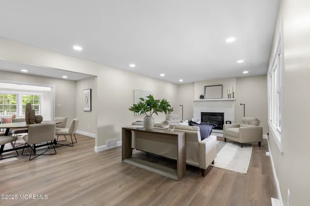 a living room with furniture a fireplace and a table