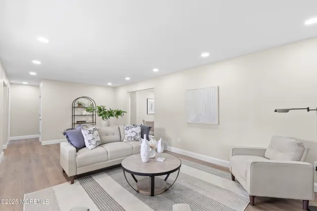 a living room with furniture and a mirror