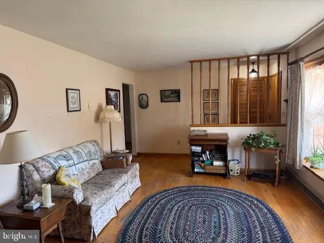 a living room with furniture a window and a refrigerator