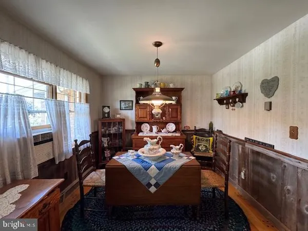 a living room with furniture a chandelier a fireplace and a window