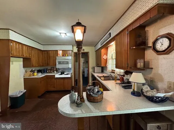 a kitchen with granite countertop a sink stove and cabinets