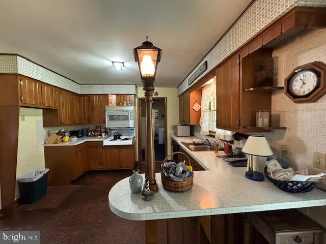 a kitchen with granite countertop a sink stove and cabinets