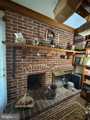 a view of a porch with chairs and floor to ceiling window