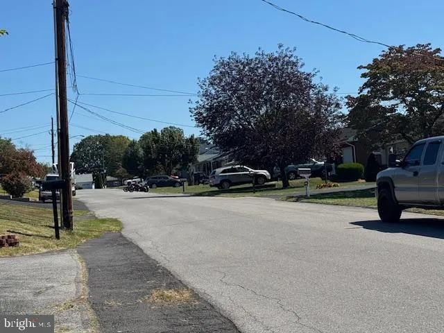 a view of street with parked cars