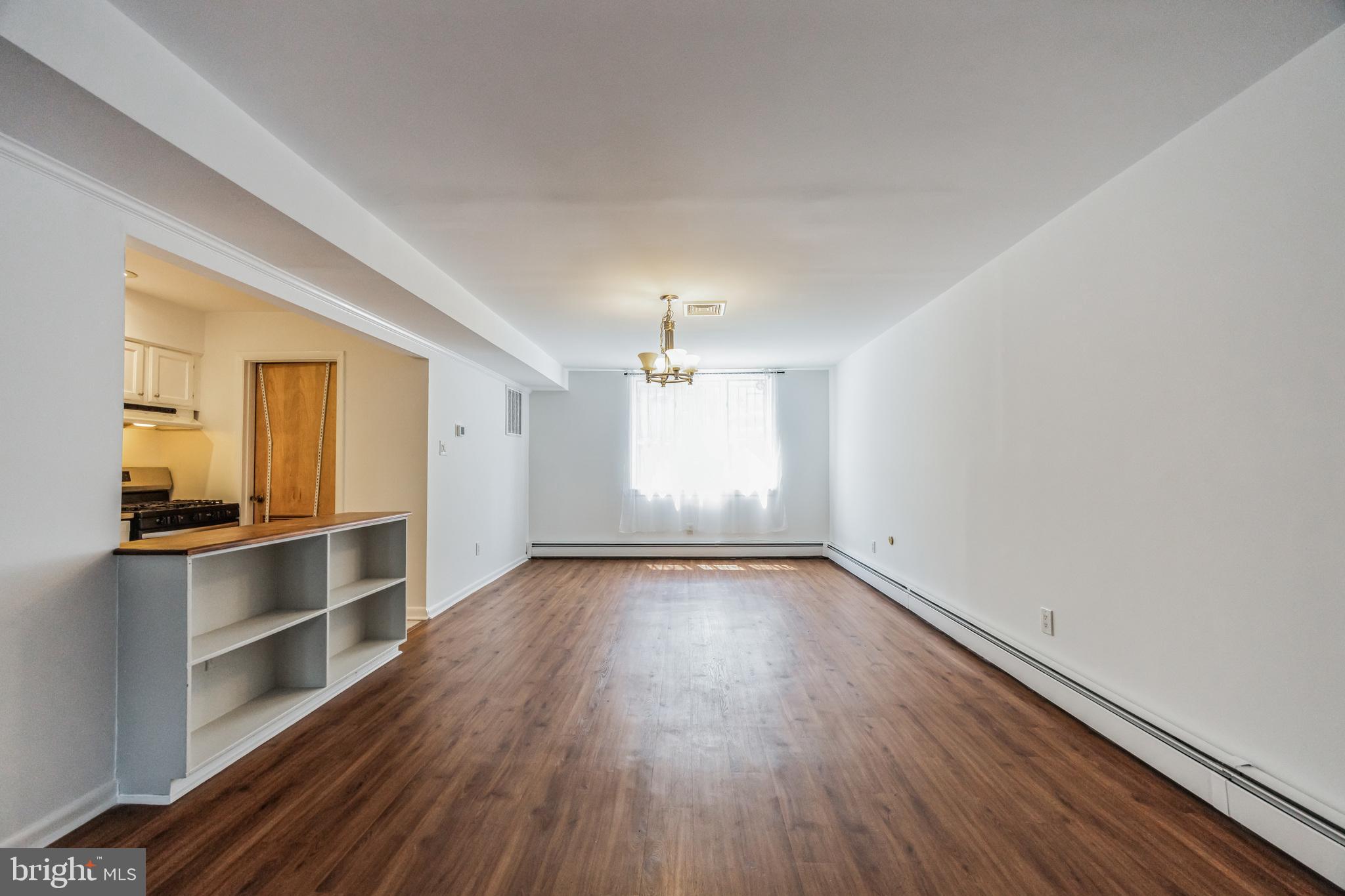 1928 Rodman Street, Unit A Philadelphia, PA 19146 - Photo 13 of 28 wooden floor in an empty room with a window