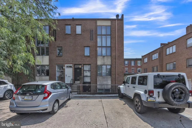 a front view of a house with parking space