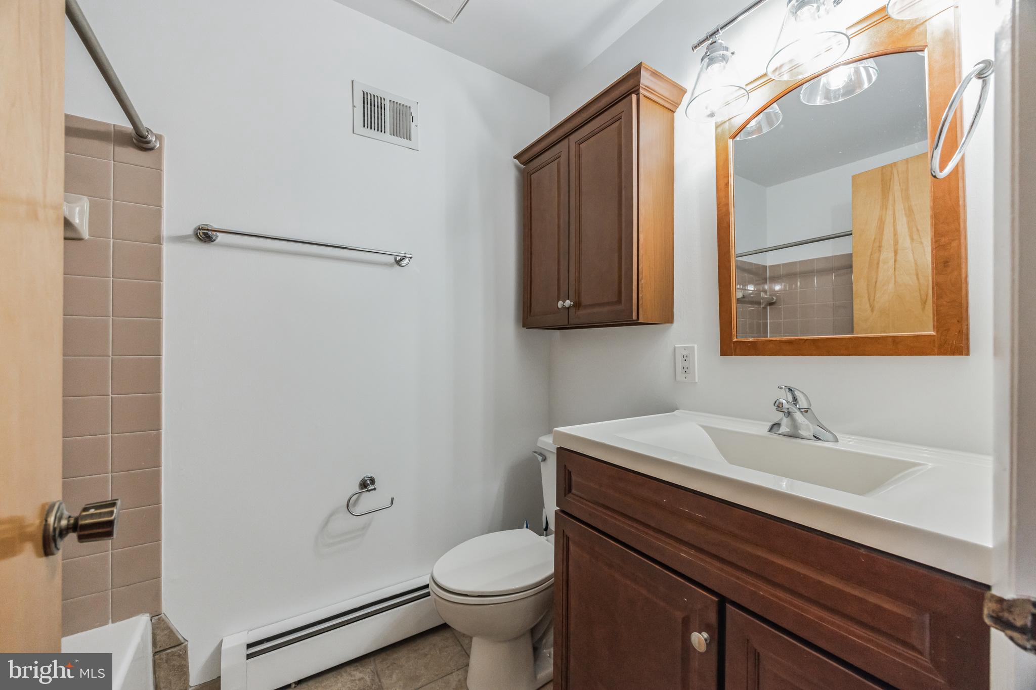 1928 Rodman Street, Unit A Philadelphia, PA 19146 - Photo 25 of 28 a bathroom with a sink toilet and shower