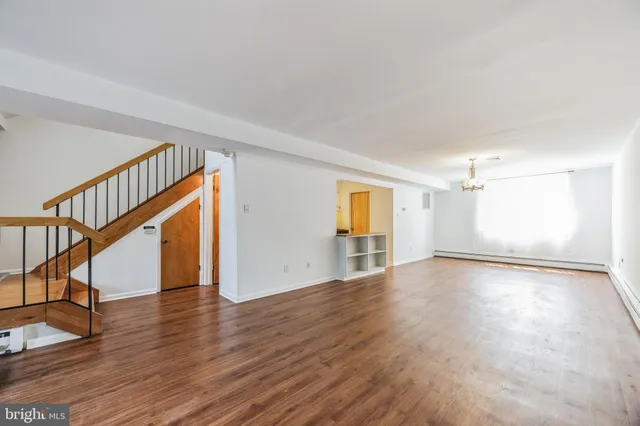 a view of a kitchen with a dishwasher and wooden floor