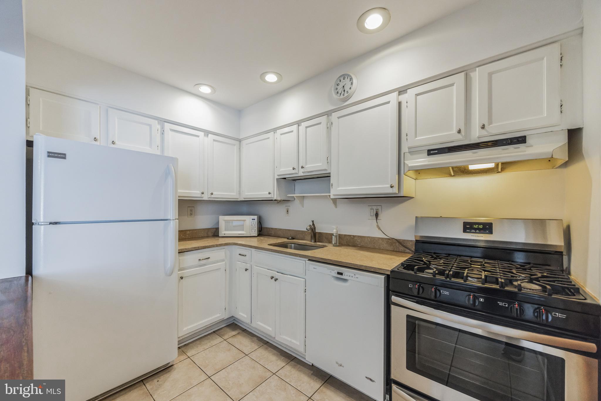 1928 Rodman Street, Unit A Philadelphia, PA 19146 - Photo 9 of 28 a kitchen with cabinets appliances and a counter space