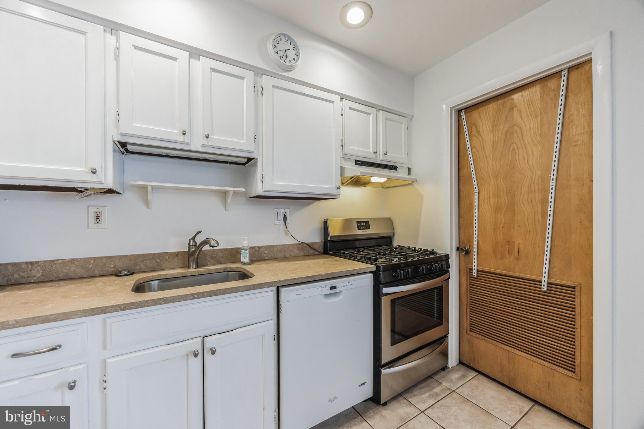 1928 Rodman Street, Unit A Philadelphia, PA 19146 - Photo 10 of 28 a kitchen with granite countertop a sink stainless steel appliances and cabinets