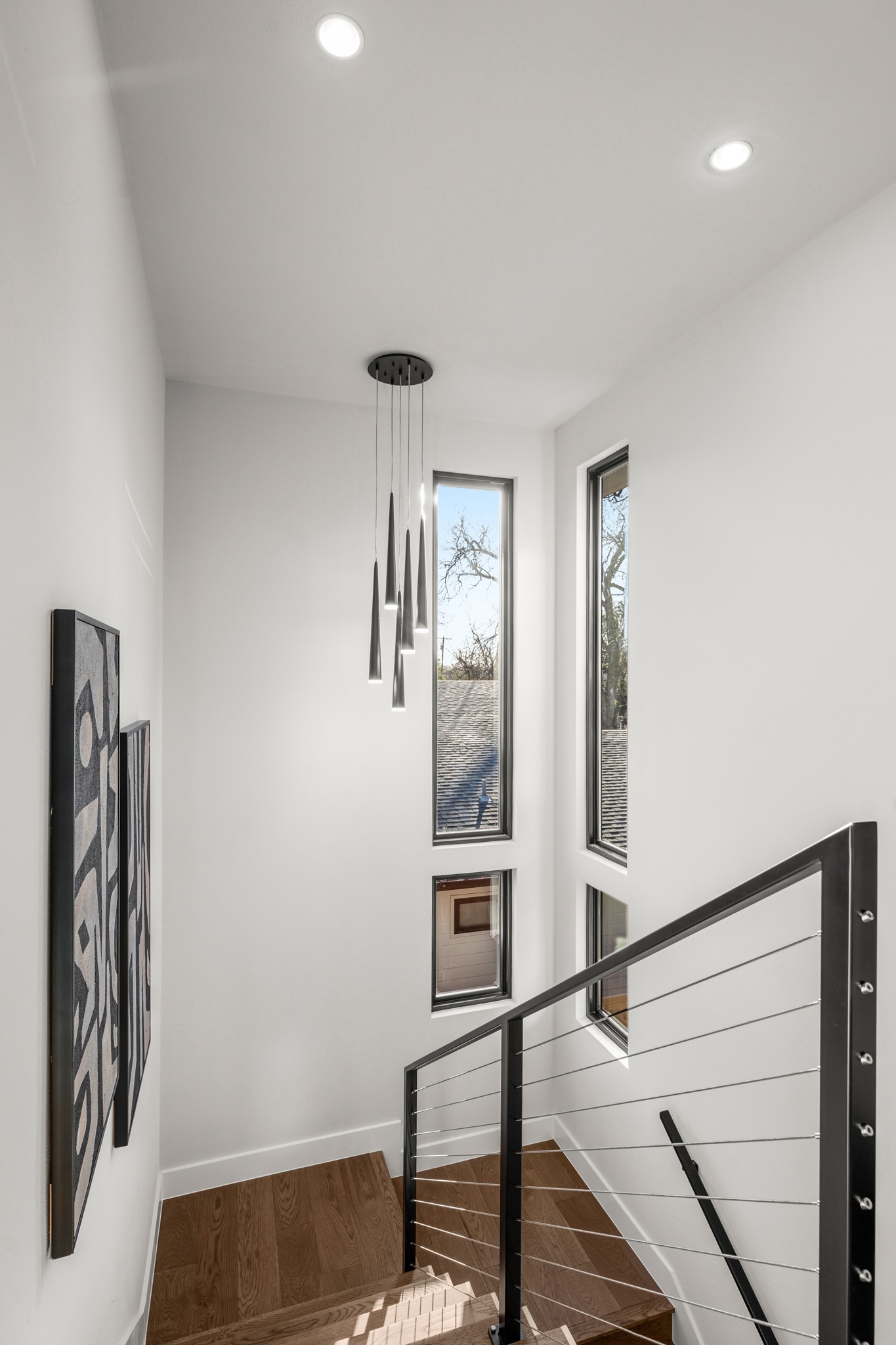 7706 Rutgers Avenue Austin, TX 78757 - Photo 31 of 35 Stairway featuring wood finished floors and recessed lighting