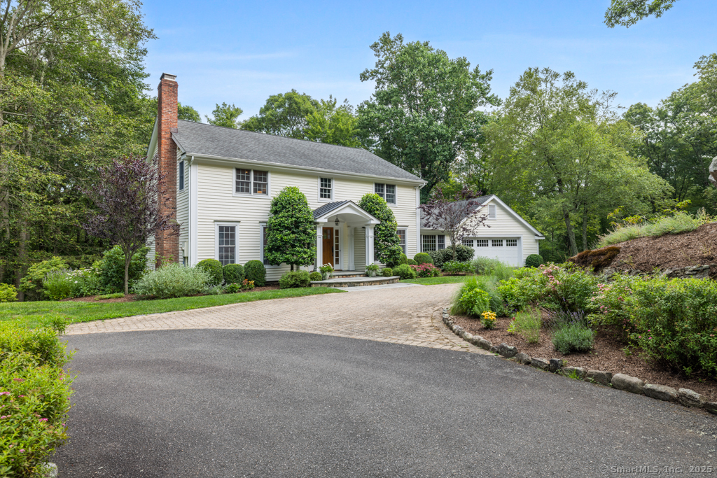 23 Mountainview Drive Redding, CT 06896 - Photo 1 of 1 a front view of a house with a yard and trees