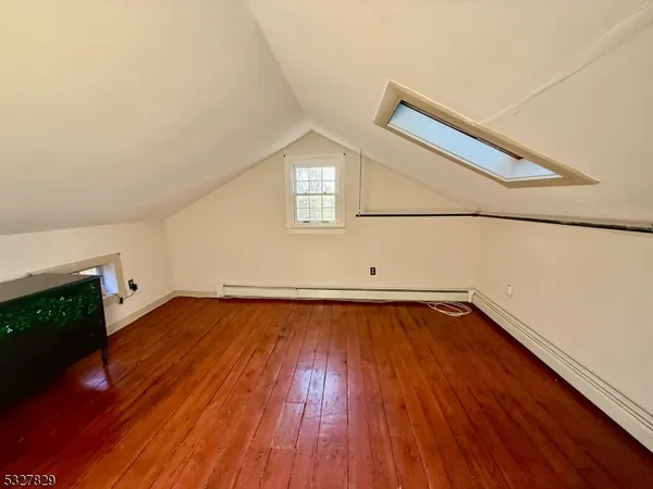 a view of a room with wooden floors and wooden floor