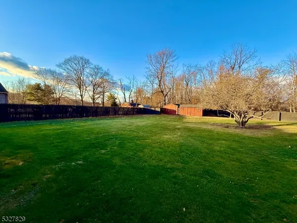 a view of a field of grass and trees