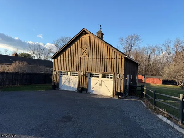 a view of backyard of house and car parked