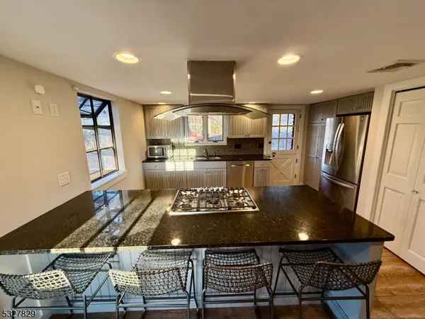 a kitchen with a dining table and chairs