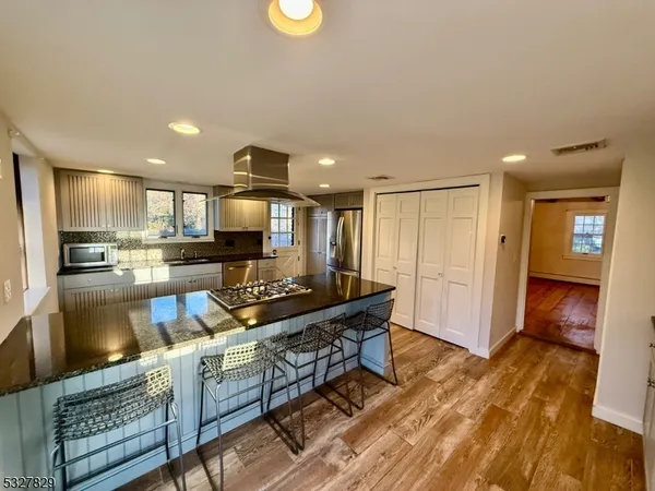 a kitchen with stainless steel appliances granite countertop a stove and a refrigerator