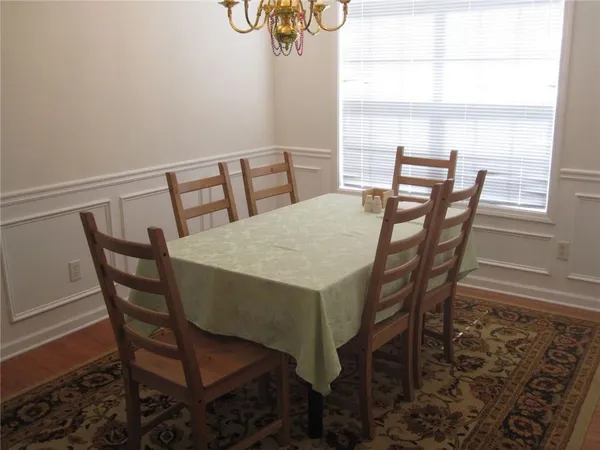 a view of a dining room with furniture and a window