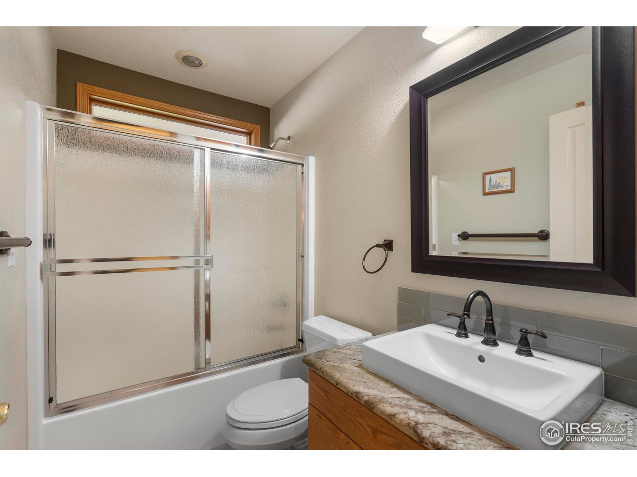 4467 West 17th Street Greeley, CO 80634 - Photo 23 of 48 a bathroom with a sink and a mirror