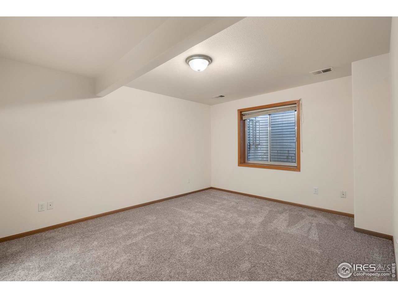 4467 West 17th Street Greeley, CO 80634 - Photo 33 of 48 a view of an empty room with wooden floor