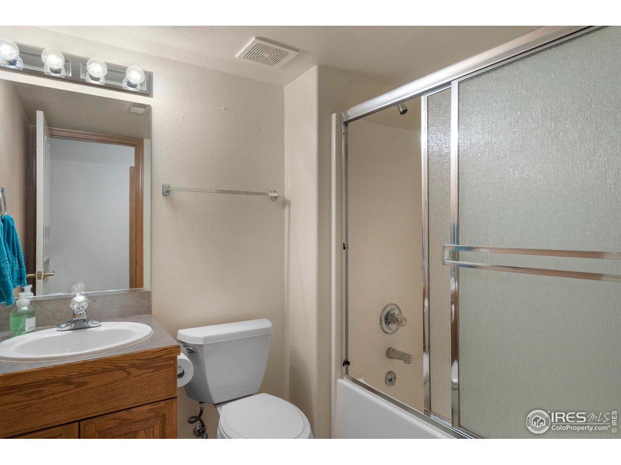4467 West 17th Street Greeley, CO 80634 - Photo 34 of 48 a bathroom with a granite countertop sink toilet and shower