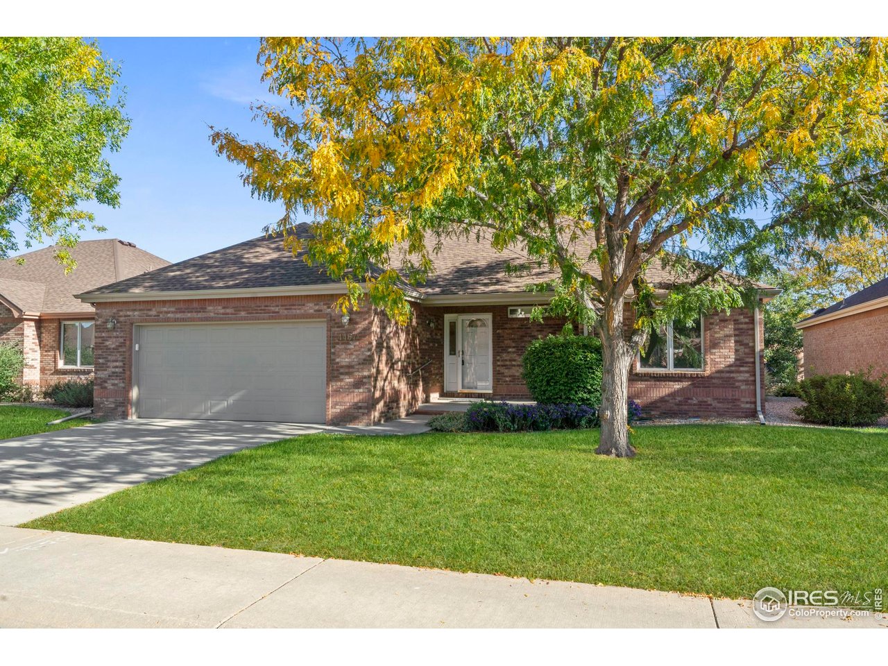 4467 West 17th Street Greeley, CO 80634 - Photo 4 of 48 a front view of a house with a garden and yard