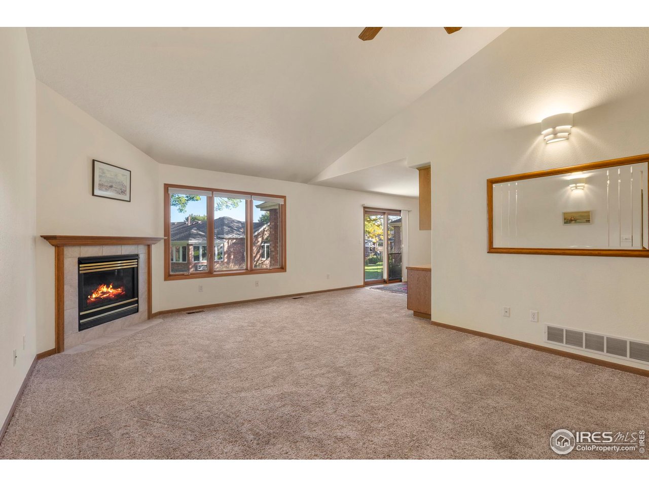 4467 West 17th Street Greeley, CO 80634 - Photo 9 of 48 a view of an empty room with a fireplace and a window