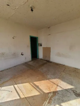 a bedroom with a bed and a night stand