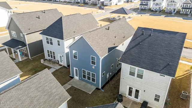 an aerial view of a house with pool and outdoor seating