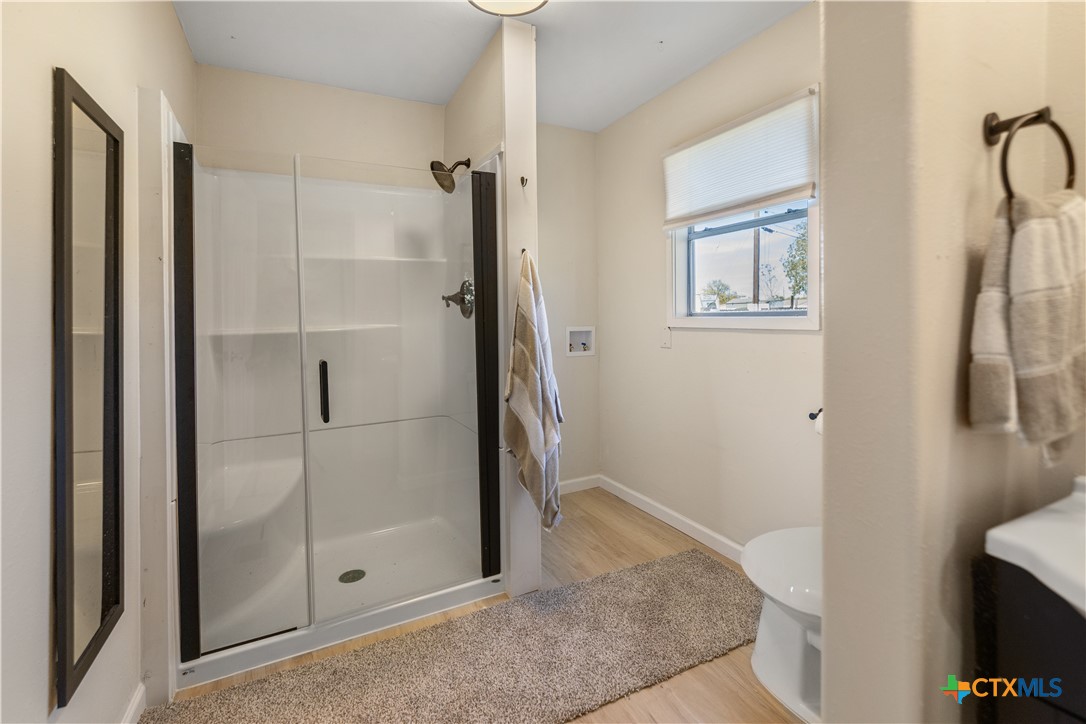 1002 East Commercial Street Victoria, TX 77901 - Photo 14 of 30 a bathroom with a shower and a glass door