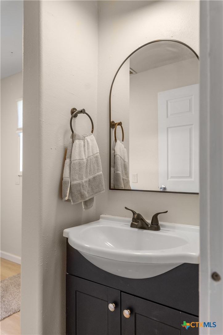1002 East Commercial Street Victoria, TX 77901 - Photo 15 of 30 a bathroom with a sink and a mirror